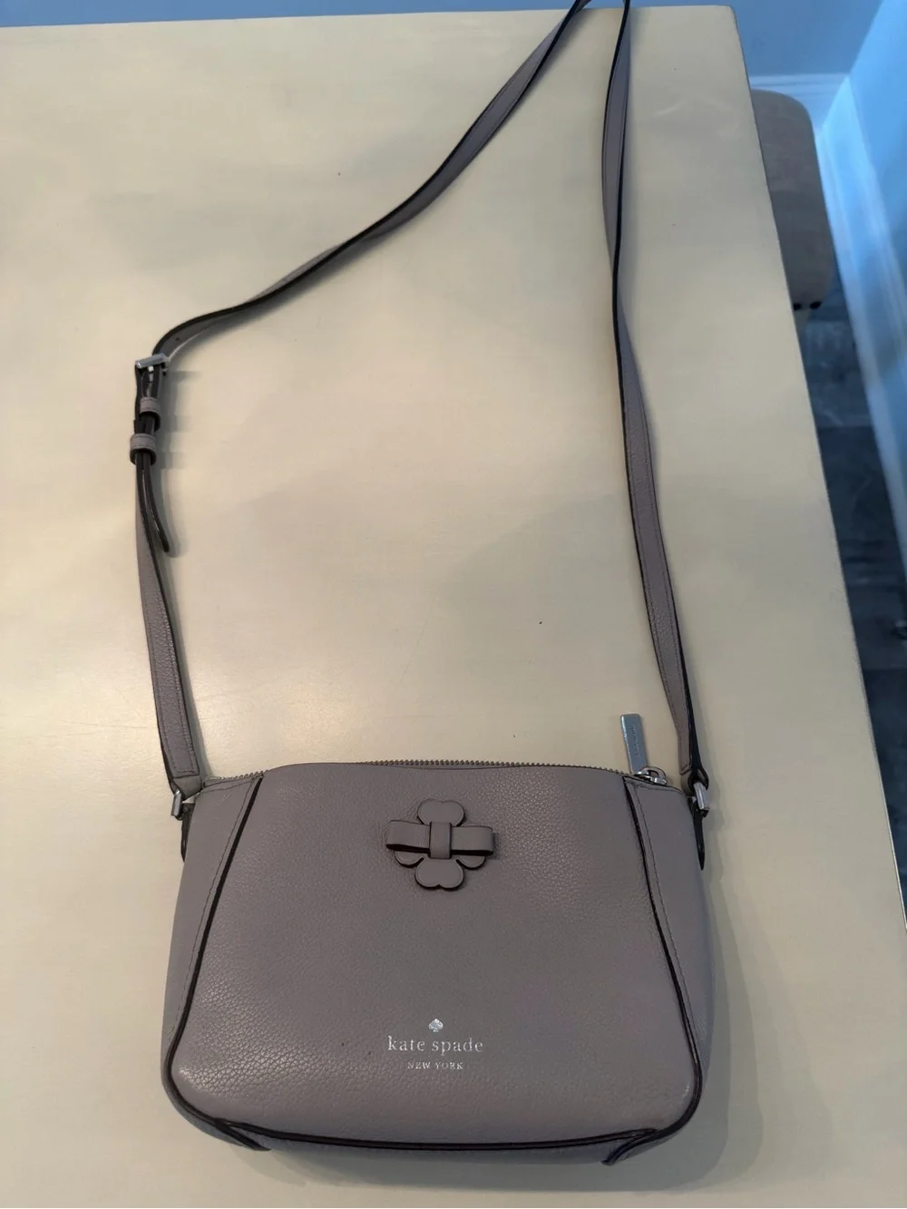 kate spade gray pebbled leather crossbody with floral logo